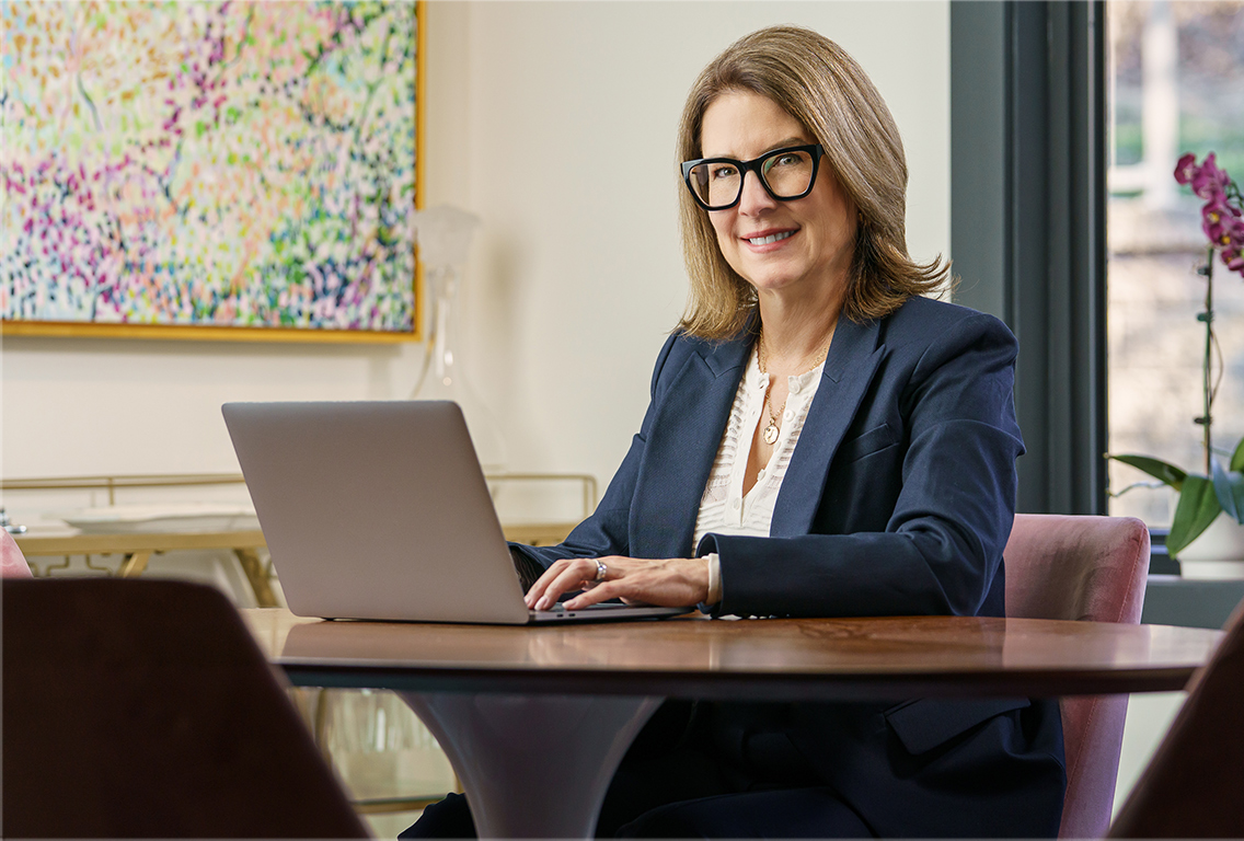 Jen Schafer working at a laptop in her office